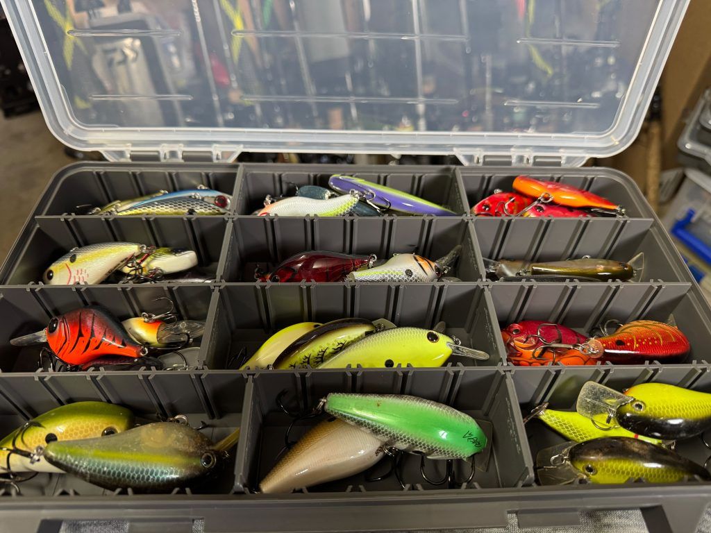 Close-up of tackle box filled with colorful fishing lures stored in organized compartments